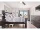 Bright bedroom featuring a ceiling fan, sliding glass doors, and a stylish patterned bedspread at 1438 S 30Th St, Mesa, AZ 85204