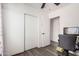 Neutral bedroom with gray wood floors, a ceiling fan, closet and open door at 1438 S 30Th St, Mesa, AZ 85204