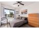 Sunlit bedroom featuring a ceiling fan and a large window with a street view at 1438 S 30Th St, Mesa, AZ 85204