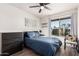 Cozy bedroom with a ceiling fan, large window, and a dark wood dresser at 1438 S 30Th St, Mesa, AZ 85204