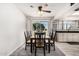 Bright dining area with black chairs, wooden table, and a window view, perfect for Gathering meals at 1438 S 30Th St, Mesa, AZ 85204