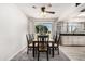 A dining room is set under a ceiling fan with a window view and stylish rug at 1438 S 30Th St, Mesa, AZ 85204