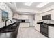 Well-lit kitchen featuring white cabinets, black countertops, and modern appliances for efficient cooking at 1438 S 30Th St, Mesa, AZ 85204