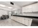 Kitchen displays modern white cabinets, dark countertops, and neutral tile flooring at 1438 S 30Th St, Mesa, AZ 85204