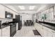 Bright, modern kitchen featuring white cabinets, black countertops, and stainless steel appliances for an appealing look at 1438 S 30Th St, Mesa, AZ 85204