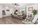 Spacious living room with plush gray sofa, ceiling fan, and natural light creating an inviting atmosphere at 1438 S 30Th St, Mesa, AZ 85204