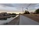 Walking path along a canal with houses in the background at 1438 S 30Th St, Mesa, AZ 85204