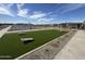 Lush green lawn set up for cornhole with a clear view of community amenities in the background at 15652 W Deanne Dr, Waddell, AZ 85355