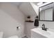 Cozy powder room featuring modern fixtures, a floating wood shelf, and a decorative floor at 1576 E Jasper Ct # E, Gilbert, AZ 85296