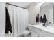 Bathroom featuring a shower with curtain, white vanity, and decorative mirror at 1576 E Jasper Ct # E, Gilbert, AZ 85296