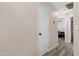 Hallway with wood-look floors leading to a room with a comfortable leather chair at 1576 E Jasper Ct # E, Gilbert, AZ 85296