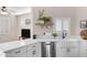 Well-lit kitchen with white cabinets, a farmhouse sink, and stainless steel appliances at 1576 E Jasper Ct # E, Gilbert, AZ 85296