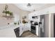 Charming kitchen featuring a farmhouse sink, white cabinets, stainless appliances, and a subway tile backsplash at 1576 E Jasper Ct # E, Gilbert, AZ 85296