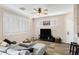 Bright living room with modern ceiling fan, shuttered windows and comfortable seating arrangement at 1576 E Jasper Ct # E, Gilbert, AZ 85296