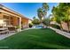 Expansive backyard featuring lush artificial turf, a refreshing pool, and ample lounging space at 16428 N 59Th St, Scottsdale, AZ 85254