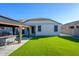 Backyard features a covered gazebo with outdoor seating and a perfectly manicured lawn at 17618 W Paraiso Dr, Surprise, AZ 85387