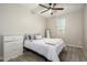 Cozy bedroom with soft carpet, a ceiling fan, and natural light, creating a relaxing atmosphere at 17618 W Paraiso Dr, Surprise, AZ 85387