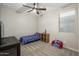 Cozy bedroom with a ceiling fan and a window for natural light at 17618 W Paraiso Dr, Surprise, AZ 85387