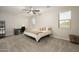 Spacious bedroom featuring a ceiling fan, desk, and ample natural light from dual windows at 17618 W Paraiso Dr, Surprise, AZ 85387