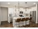 Modern kitchen features white cabinets, stainless steel appliances, and marble countertops at 17618 W Paraiso Dr, Surprise, AZ 85387