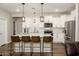 Beautiful kitchen featuring white cabinets, stainless steel appliances, a marble counter and stylish pendant lighting at 17618 W Paraiso Dr, Surprise, AZ 85387