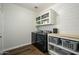 Well-organized laundry room equipped with modern washer, dryer, storage cabinets, and folding area at 17618 W Paraiso Dr, Surprise, AZ 85387