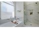 Elegant bathroom featuring a soaking tub and glass shower, enhanced by marble countertops and bronze fixtures at 1881 E Erie St, Chandler, AZ 85225