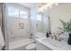 Stylish bathroom features a shower and tub, a modern sink, and marble-style tile at 1881 E Erie St, Chandler, AZ 85225