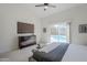 Bright bedroom features a ceiling fan, a dresser with a TV and a sliding glass door leading to the pool at 1881 E Erie St, Chandler, AZ 85225