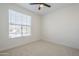 Neutral bedroom with natural light and a ceiling fan, ready for personalized touches at 1881 E Erie St, Chandler, AZ 85225