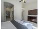 Bright bedroom features a ceiling fan, a dresser with a TV and an archway leading to the bathroom at 1881 E Erie St, Chandler, AZ 85225