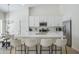 Open floor plan kitchen featuring white cabinets, a quartz island, and stainless steel appliances at 1881 E Erie St, Chandler, AZ 85225