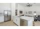 Bright kitchen boasts an island with a sink, stainless steel appliances, and modern white cabinetry at 1881 E Erie St, Chandler, AZ 85225