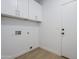 Bright laundry room with white cabinets, gold hardware, and a convenient layout at 1881 E Erie St, Chandler, AZ 85225