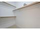 Bright walk-in closet featuring built-in shelving at 1881 E Erie St, Chandler, AZ 85225