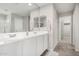 Bathroom featuring tile floors, a double sink, and a doorway to a closet at 19242 W Madison St, Buckeye, AZ 85326