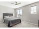 This bedroom features neutral paint, carpet, a ceiling fan, and two windows at 19242 W Madison St, Buckeye, AZ 85326