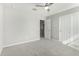 Bedroom featuring neutral paint, carpet, a ceiling fan, and a sliding closet door at 19242 W Madison St, Buckeye, AZ 85326