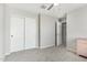 Bedroom featuring neutral paint, carpet, and a sliding closet door at 19242 W Madison St, Buckeye, AZ 85326