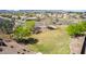 An aerial view shows a sprawling community park with green spaces, trees and playground equipment at 19242 W Madison St, Buckeye, AZ 85326