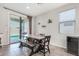 Bright dining area with a large table, bench seating, and sliding glass doors to the patio at 19242 W Madison St, Buckeye, AZ 85326