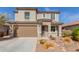 Charming two-story home with desert landscaping, a secure front door and a two car garage at 19242 W Madison St, Buckeye, AZ 85326