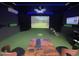 Indoor golf simulator room featuring a projector screen, golf mat, and comfortable seating at 19242 W Madison St, Buckeye, AZ 85326