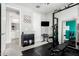 Bright home gym featuring modern workout equipment, a wall-mounted TV, and inviting decor at 19242 W Madison St, Buckeye, AZ 85326