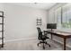 Cozy home office featuring a desk, chair, and natural light from the window at 19242 W Madison St, Buckeye, AZ 85326