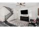 Cozy living room featuring modern furniture, neutral tones, and staircase to second floor at 19242 W Madison St, Buckeye, AZ 85326