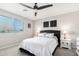 Serene main bedroom with a ceiling fan, window and decorative wall art creating a relaxing space at 19242 W Madison St, Buckeye, AZ 85326