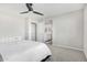 This bedroom features neutral paint, carpet, a ceiling fan, and an ensuite bath at 19242 W Madison St, Buckeye, AZ 85326