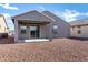 Cozy backyard with a covered patio perfect for outdoor entertaining and leisure at 20670 N Confetti Ct, Maricopa, AZ 85138