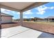 Covered patio featuring neutral concrete flooring, perfect for relaxing and enjoying the neighborhood at 20670 N Confetti Ct, Maricopa, AZ 85138